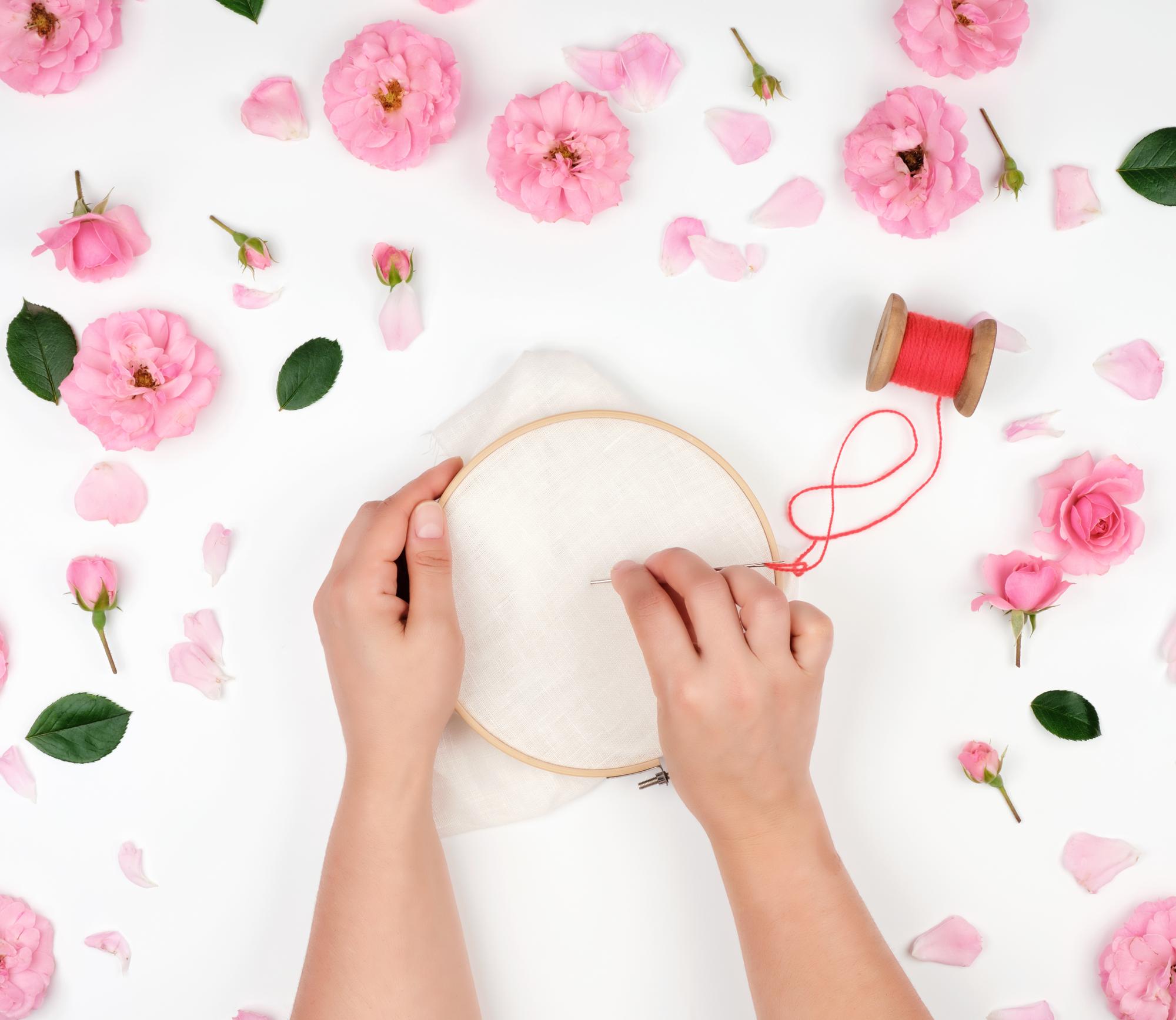 Artist at work stitching floral pattern